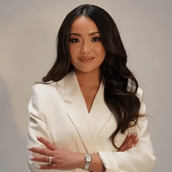 Professional headshot of Jenesa Aguiluz-Dizon, Medical Director at iCare Medical Clinic in a white blazer.